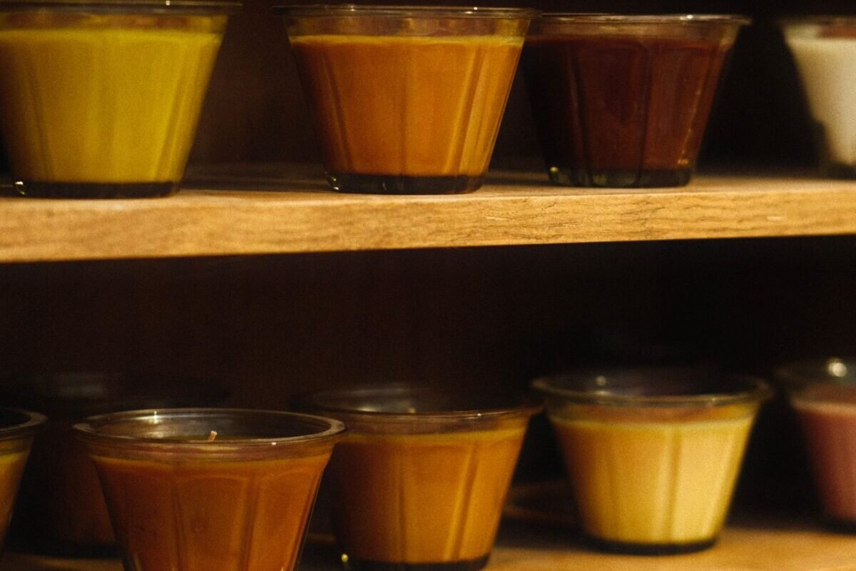 things to declutter small home fast – candles in glass jars lined up on wooden shelves