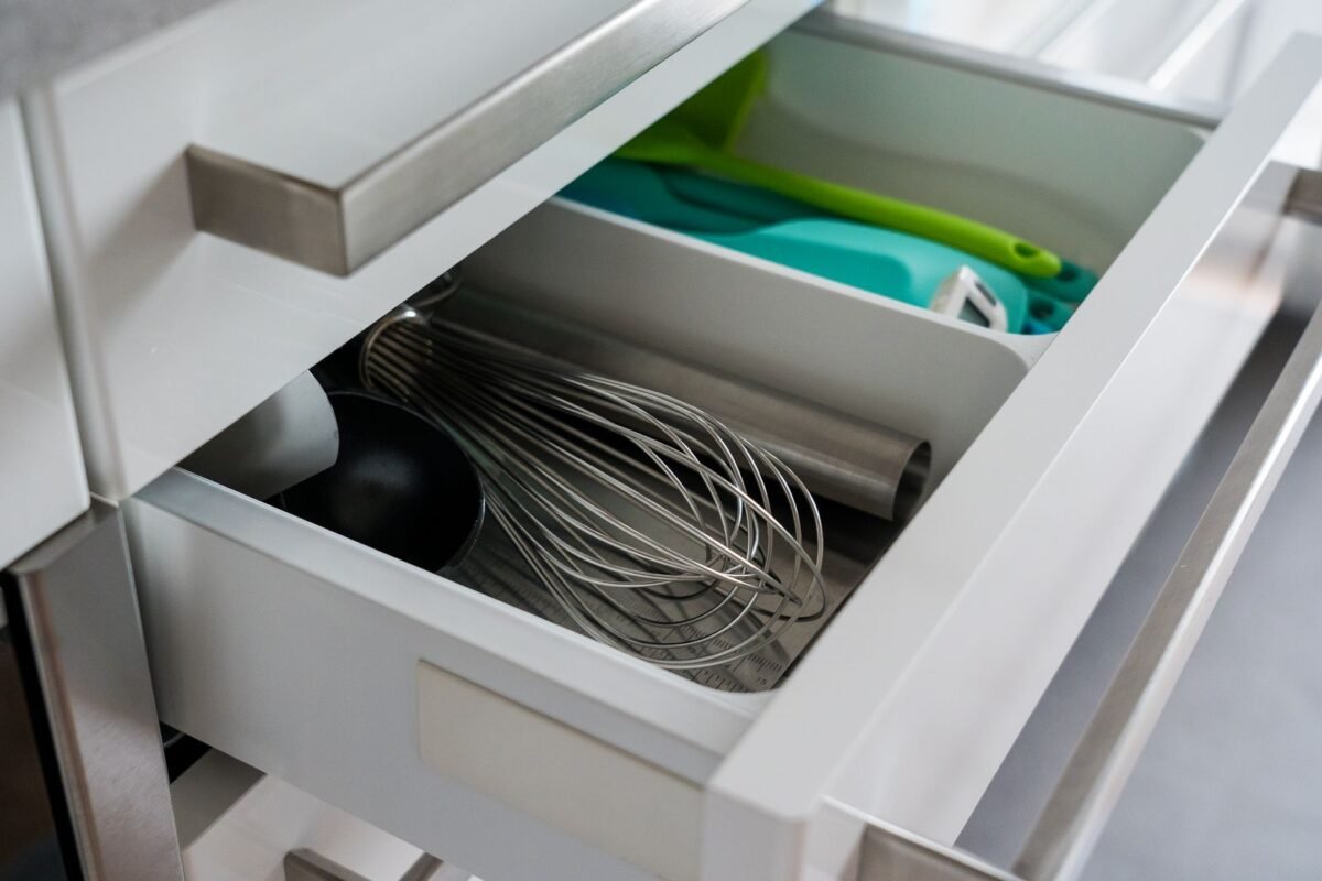 things to declutter small home fast – open kitchen drawer full of cooking utensils