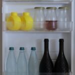 things to declutter small home fast – open fridge door shelves full of bottles and jars