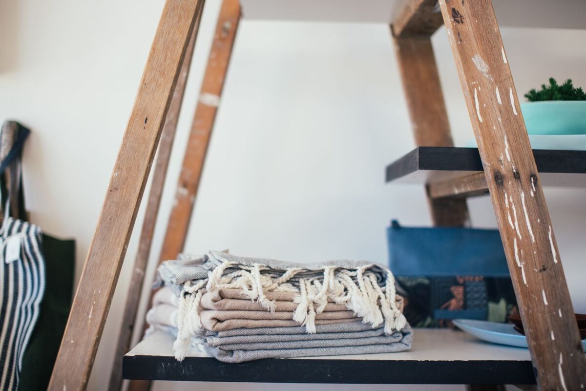 things to declutter small home fast – stack of folded towels on a shelf at home