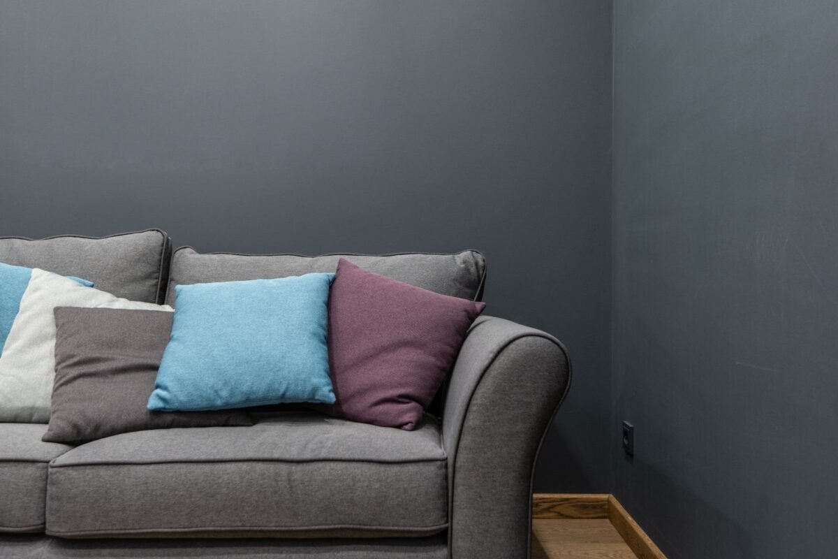 things to declutter small home fast – gray sofa crowded with too many throw pillows