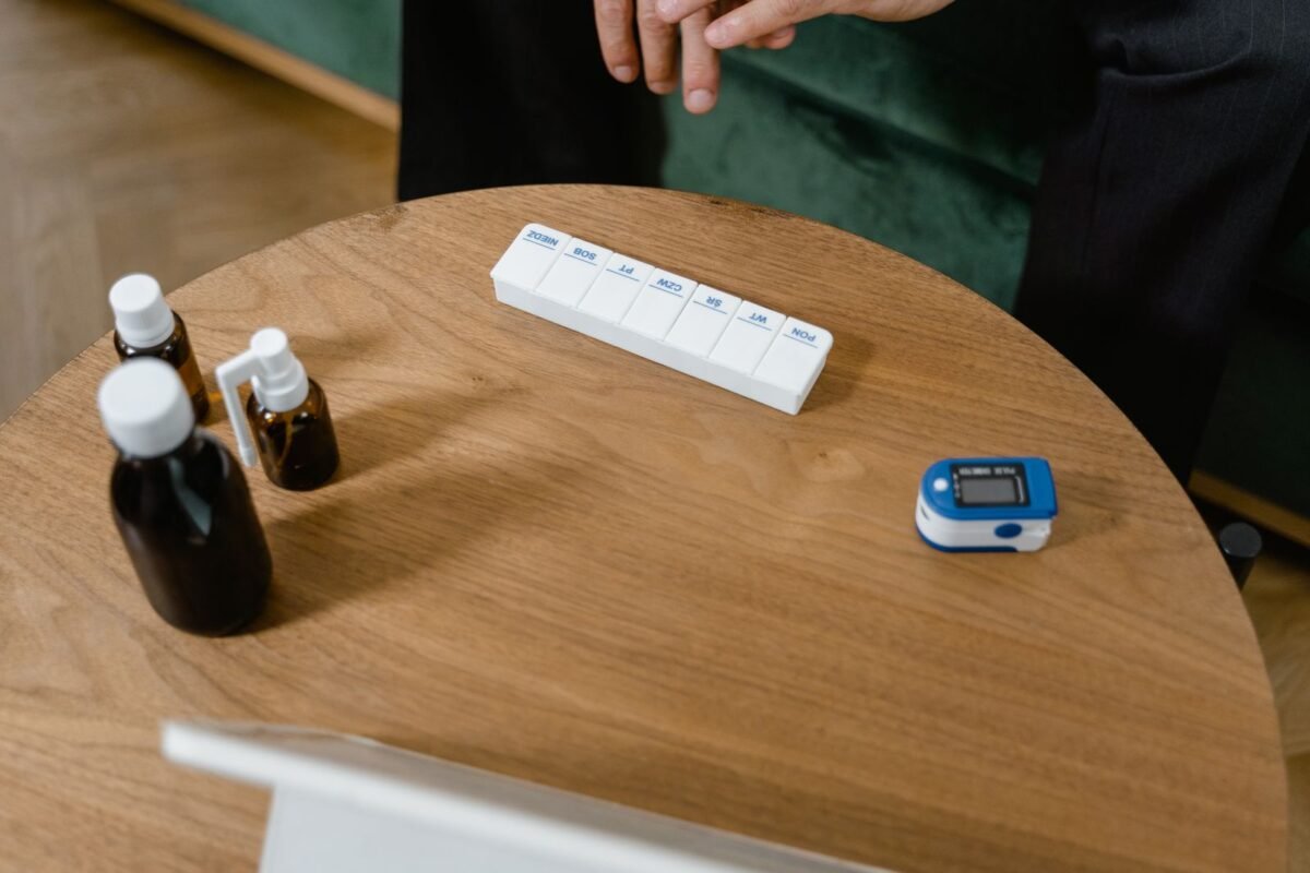 things to declutter small home fast – medicine bottles and a pill organizer on a table