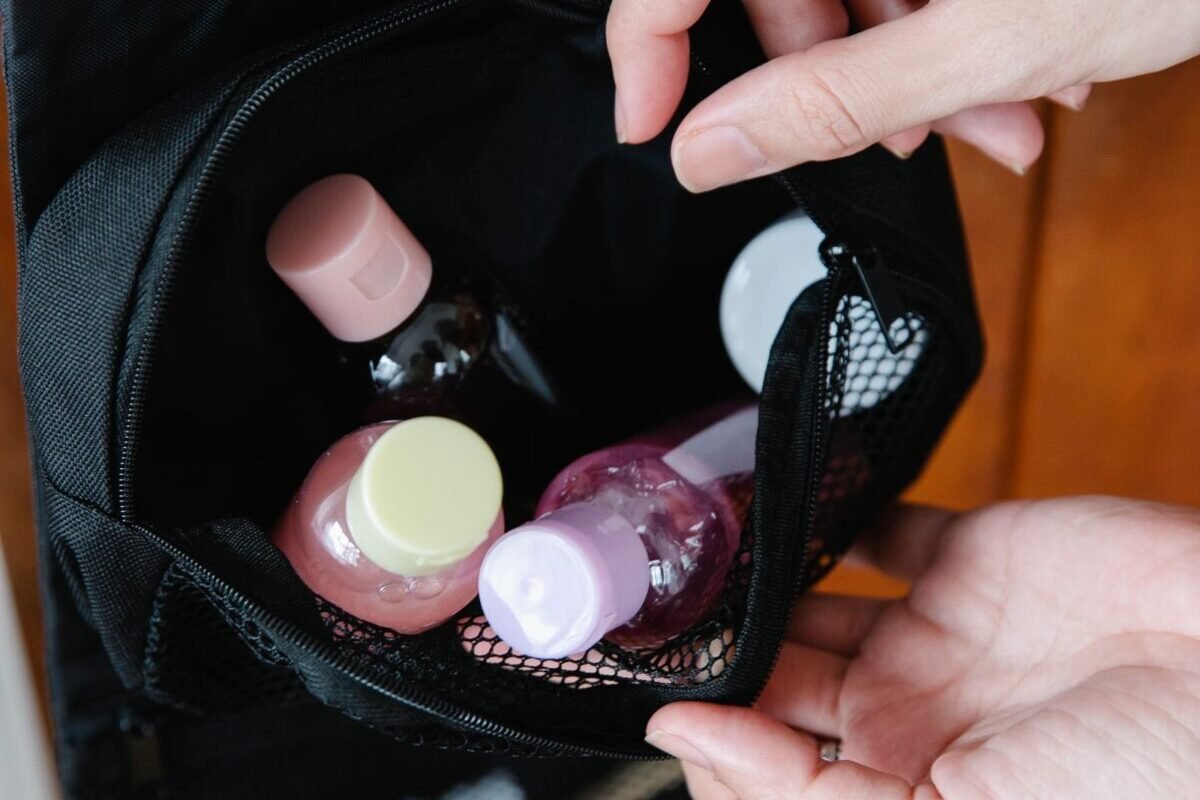 things to declutter small home fast – small travel toiletry bottles in a black pouch