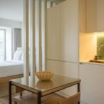 How to divide a studio apartment: a studio split into a sleep zone and a kitchen by a slatted divider