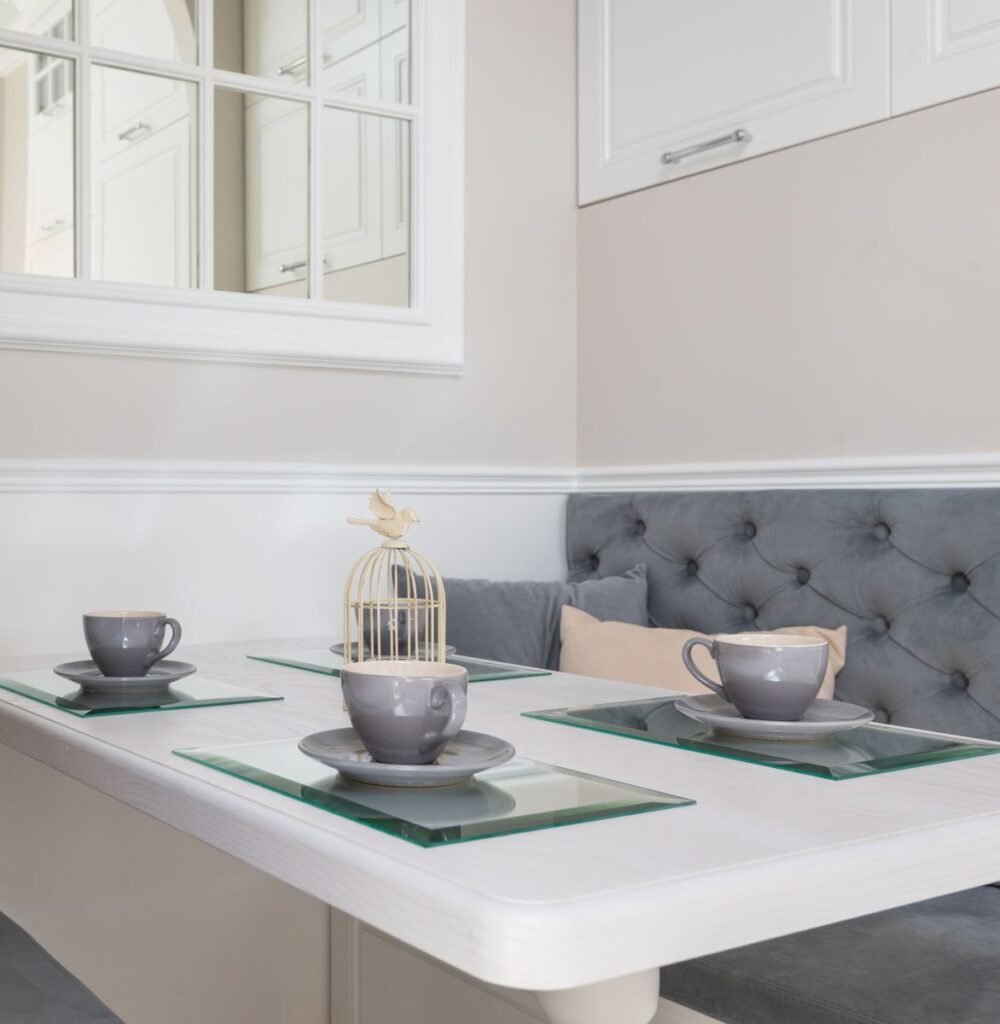 Small kitchen storage ideas for apartments: a dining nook with a bench seat tucked into an eat-in corner