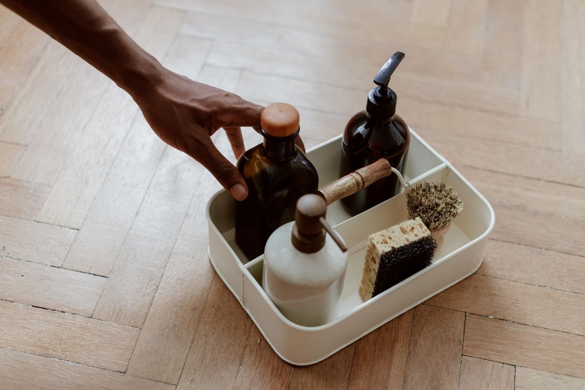 Kitchen cabinet organization ideas: cleaning supplies corralled in a handled caddy that slides into the sink cabinet.