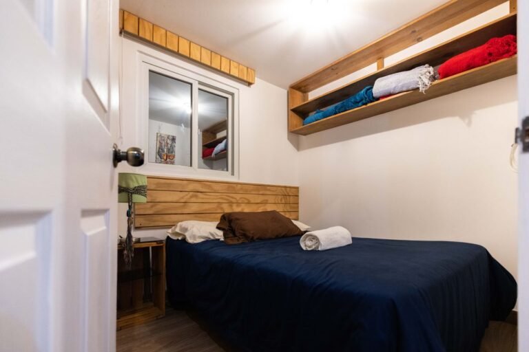 Small bedroom storage ideas no closet: a cozy organized bedroom with a comfy bed and wooden shelves