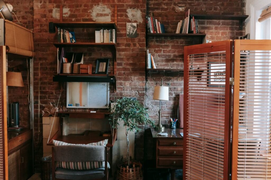 Wooden folding screen used as a movable room divider in a studio apartment layout
