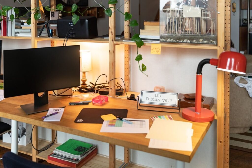 Task lighting on a small desk in a studio apartment layout, signaling work mode in the work zone