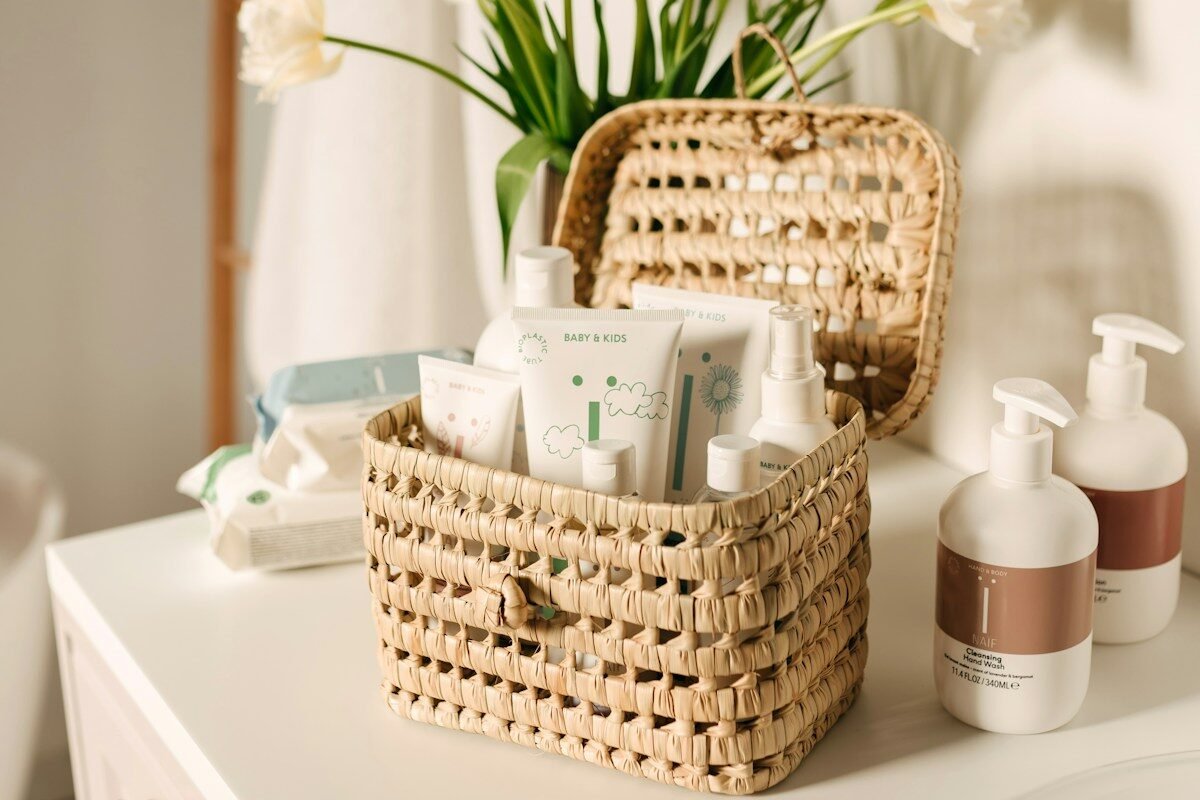 Small bathroom storage ideas no counter space: a small wicker basket holding toiletries beside a bathroom sink